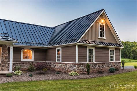 black metal roof on tan house|ranch homes with black roof.